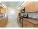 Kitchen with wood cabinets, tile backsplash, stainless steel appliances, and breakfast nook at 39055 9Th Ave, Zephyrhills, FL 33542