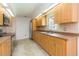 Kitchen with wood cabinets, tile backsplash, stainless steel appliances, and breakfast nook at 39055 9Th Ave, Zephyrhills, FL 33542