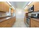 Kitchen with wood cabinets, tile backsplash, stainless steel appliances, and breakfast nook at 39055 9Th Ave, Zephyrhills, FL 33542