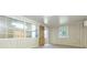Bright living room featuring light walls, an open door, and large windows for plenty of natural light at 39055 9Th Ave, Zephyrhills, FL 33542