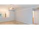 Open-concept living room featuring vaulted ceilings, ceiling fan, and tile flooring at 39055 9Th Ave, Zephyrhills, FL 33542