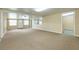 Spacious, brightly lit living room offering access to multiple doors and windows at 39055 9Th Ave, Zephyrhills, FL 33542