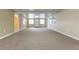 Spacious, brightly lit living room offering access to multiple doors and windows at 39055 9Th Ave, Zephyrhills, FL 33542