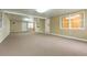 Spacious, brightly lit living room offering access to multiple doors and windows at 39055 9Th Ave, Zephyrhills, FL 33542
