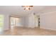Bright and airy living room featuring tile flooring and open sightlines to the foyer and kitchen at 39055 9Th Ave, Zephyrhills, FL 33542