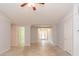Spacious living room with tile floors, neutral paint, ceiling fan and views to the entry at 39055 9Th Ave, Zephyrhills, FL 33542