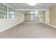 Spacious, brightly lit living room offering access to multiple doors and windows at 39055 9Th Ave, Zephyrhills, FL 33542