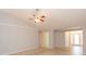 Open living room with neutral walls, tile flooring, and arches to other rooms at 39055 9Th Ave, Zephyrhills, FL 33542