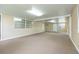 Spacious, brightly lit living room offering access to multiple doors and windows at 39055 9Th Ave, Zephyrhills, FL 33542