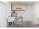 A view of the utility room with water heater, sink, and lots of storage, all in a spacious area at 39055 9Th Ave, Zephyrhills, FL 33542