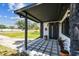 Inviting covered home entrance with dark accents, stylish outdoor lighting, modern door, and tasteful landscaping at 400 83Rd Ne Ave, St Petersburg, FL 33702