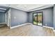 Cozy room featuring a sliding glass door and modern wood flooring at 400 83Rd Ne Ave, St Petersburg, FL 33702