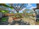 Large backyard featuring a wooden fence, mature trees, planted vegetation, and areas for gardening and relaxation at 4642 29Th N Ave, St Petersburg, FL 33713