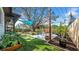 Lush backyard featuring a modern patio area, manicured artificial turf, and a variety of garden beds and plants at 4642 29Th N Ave, St Petersburg, FL 33713