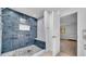 Walk-in shower with pebble floor, dark blue tile, and a built-in bench at 4642 29Th N Ave, St Petersburg, FL 33713