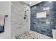 Remodeled shower with marble-look tile and rain shower head at 4642 29Th N Ave, St Petersburg, FL 33713