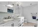 Bright bathroom featuring a double vanity with marble countertops and modern fixtures at 4642 29Th N Ave, St Petersburg, FL 33713