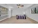 Light bedroom with hardwood floors, shelving, and a ceiling fan, creating a comfortable and relaxing atmosphere at 4642 29Th N Ave, St Petersburg, FL 33713