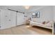 Well-lit bedroom with a barn door, laminate flooring, and vanity area, offering a comfortable retreat at 4642 29Th N Ave, St Petersburg, FL 33713