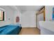 Cozy bedroom featuring a blue bedspread, natural light from the window, and ample storage space, creating a tranquil retreat at 4642 29Th N Ave, St Petersburg, FL 33713