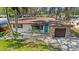 Charming single-story home featuring stone accents, fresh landscaping and a vibrant blue front door at 4642 29Th N Ave, St Petersburg, FL 33713