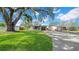 Inviting home with a well-manicured lawn, mature trees, a driveway, and a charming stone accent on the garage at 4642 29Th N Ave, St Petersburg, FL 33713