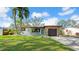 Charming single-story home featuring a stone facade, attached garage, manicured lawn, and mature landscaping at 4642 29Th N Ave, St Petersburg, FL 33713