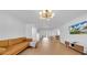 Bright living room with modern lighting, a tan leather couch, and hardwood floors, creating a welcoming and stylish space at 4642 29Th N Ave, St Petersburg, FL 33713