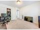 A carpeted bedroom features a spacious closet and doorway to other rooms at 4732 Ashburn Pond Way, Tampa, FL 33610