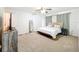 Relaxing bedroom with carpet, ceiling fan, and ensuite bath for a comfortable and peaceful retreat at 4732 Ashburn Pond Way, Tampa, FL 33610