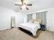 Bright bedroom features plush carpet, ceiling fan, and neutral decor providing a serene retreat at 4732 Ashburn Pond Way, Tampa, FL 33610