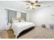 Cozy bedroom with neutral carpet, ceiling fan, and minimalist decor for a comfortable and relaxing space at 4732 Ashburn Pond Way, Tampa, FL 33610