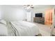 A bright bedroom boasts a ceiling fan, neutral carpet, and ensuite bath for a relaxing retreat at 4732 Ashburn Pond Way, Tampa, FL 33610