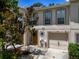 Charming two-story townhouse featuring an attached garage and a welcoming front entrance with decorative wreath at 4732 Ashburn Pond Way, Tampa, FL 33610