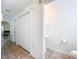 Hallway featuring a half-bathroom, tiled floors, and a large closet at 4732 Ashburn Pond Way, Tampa, FL 33610