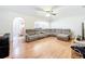 Bright and spacious living room features hardwood floors and a large sectional sofa at 4732 Ashburn Pond Way, Tampa, FL 33610