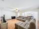 Comfortable living room showcasing an expansive sectional sofa and hardwood floors at 4732 Ashburn Pond Way, Tampa, FL 33610