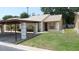 Charming single-story home with a covered carport and well-maintained front yard at 4736 Sunny Loop, Holiday, FL 34690
