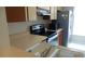 Modern kitchen with stainless steel appliances and practical layout at 4736 Sunny Loop, Holiday, FL 34690