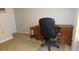 Home office setup with desk, chair, and carpet, creating a functional workspace in a residential setting at 4736 Sunny Loop, Holiday, FL 34690