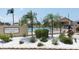 Community pool area featuring palm trees, lounge chairs, and a clubhouse, creating a relaxing outdoor space at 4736 Sunny Loop, Holiday, FL 34690