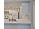 Bright kitchen with stainless steel sink, white cabinets and a breakfast bar at 4801 W Mcelroy Ave # D104, Tampa, FL 33611