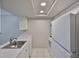 Kitchen with stainless steel sink, white cabinets and plenty of light at 4801 W Mcelroy Ave # D104, Tampa, FL 33611