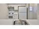 Efficient kitchen featuring white appliances, tile floors, overhead lighting, and ample counter space at 4801 W Mcelroy Ave # D104, Tampa, FL 33611