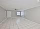 Spacious living room with tiled floors, a large window letting in natural light, and a ceiling fan at 4801 W Mcelroy Ave # D104, Tampa, FL 33611