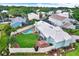 Aerial view of a property featuring a pool, well-maintained lawn, and mature trees in a residential neighborhood at 500 Westborough Ln, Safety Harbor, FL 34695