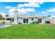 Spacious backyard with manicured lawn and pool, perfect for outdoor entertaining and relaxation at 500 Westborough Ln, Safety Harbor, FL 34695