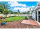 Well-maintained backyard featuring lush green grass, a fence, landscaping, and a view of the pool at 500 Westborough Ln, Safety Harbor, FL 34695