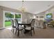 Open-concept space with dining area, stylish chandelier, and a view of the outdoor greenery at 500 Westborough Ln, Safety Harbor, FL 34695