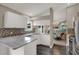 Bright kitchen featuring granite countertops, white cabinetry, stainless steel appliances, and an open layout at 500 Westborough Ln, Safety Harbor, FL 34695